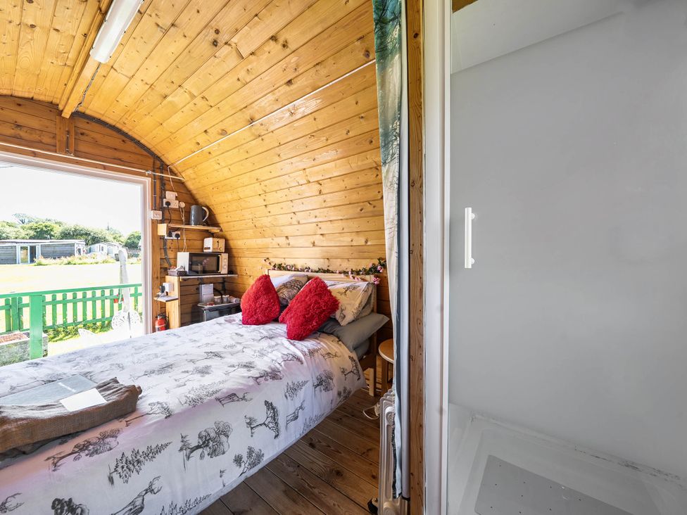 A bedroom with a bed and kitchenette area at St Austell Glamping in St Austell