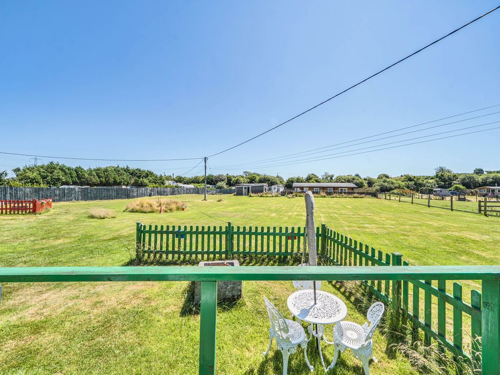 An outdoor area with a table and chairs at St Austell Glamping in St Austell