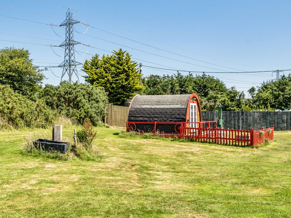 An outdoor area with a yurt, fencing, and power lines at St Austell Glamping in St Austell