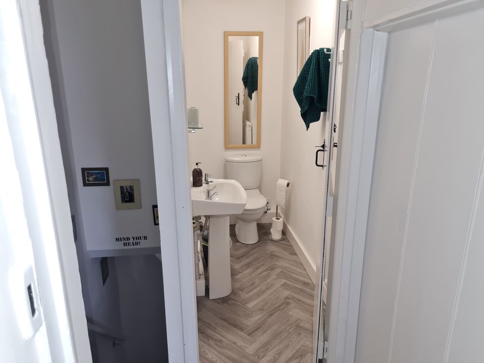 A bathroom with a toilet and sink at Charming Lincoln Cottage