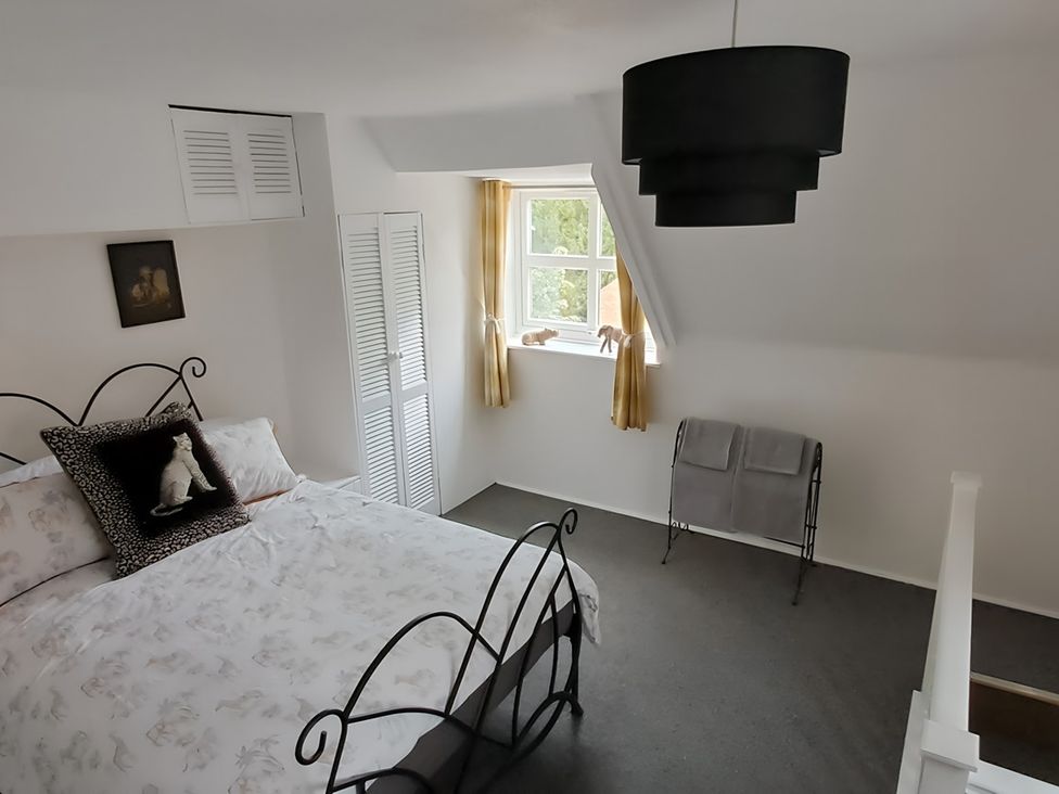 A bedroom with a bed and window at Charming Lincoln Cottage