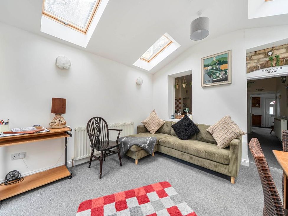 A snug with a sofa and desk at Charming Lincoln Cottage in Lincoln