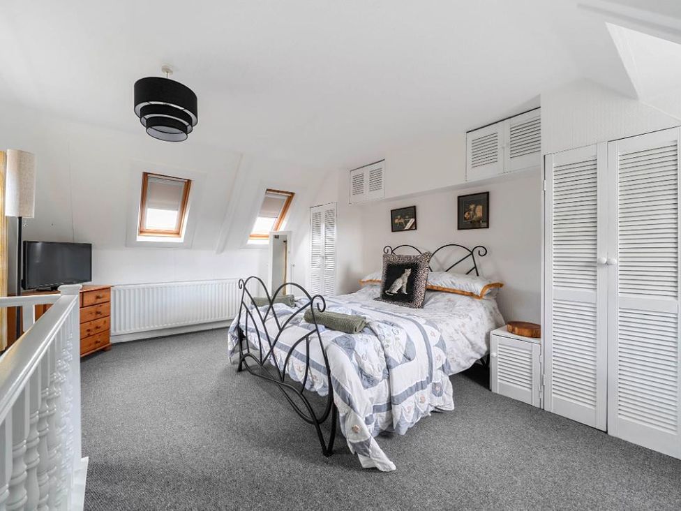 A bedroom with a bed and dresser at Charming Lincoln Cottage in Lincoln