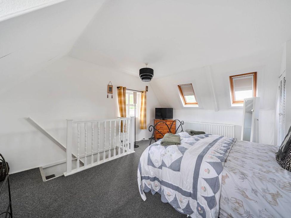 A bedroom with a bed and TV at Charming Lincoln Cottage in Lincoln