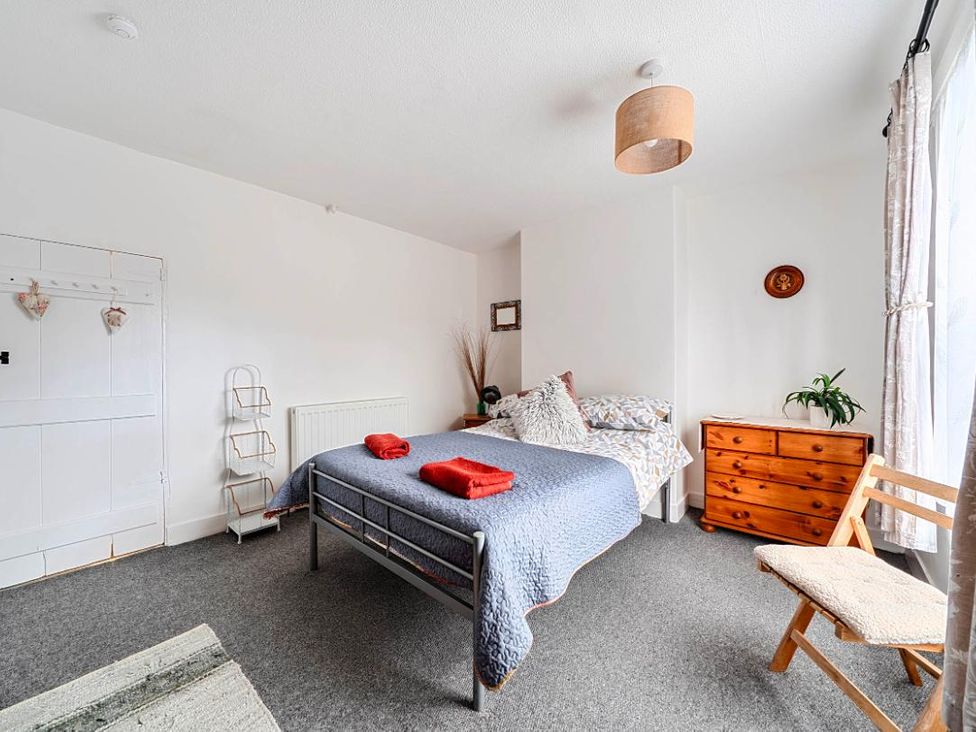 A bedroom with a bed and a dresser at Charming Lincoln Cottage in Lincoln