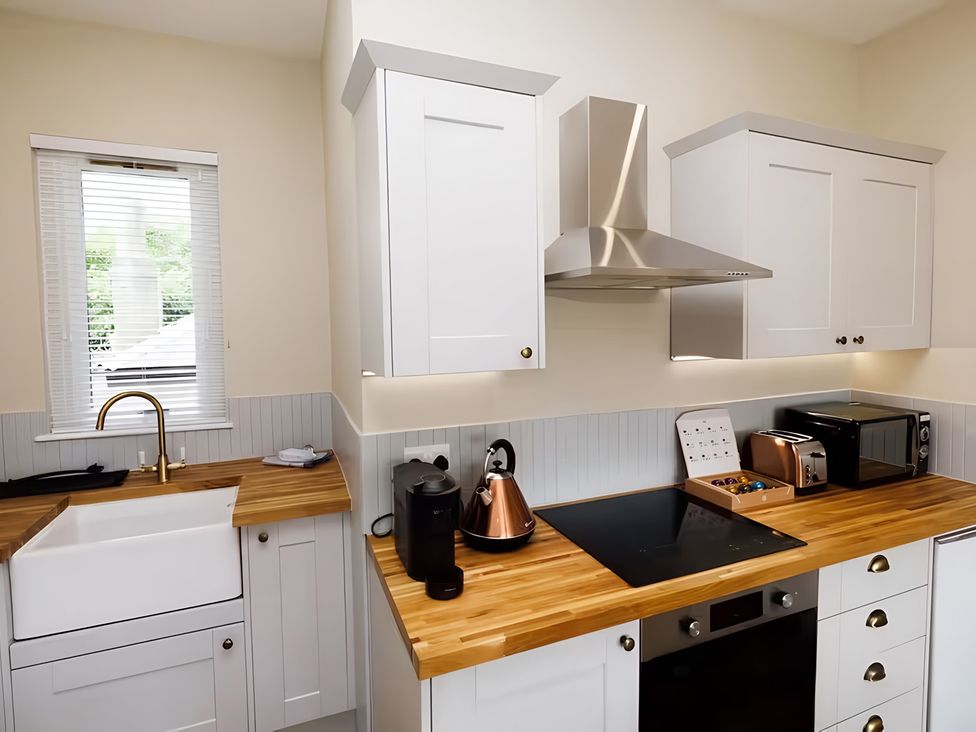 A kitchen with a sink and appliances at 15B Kirkgate