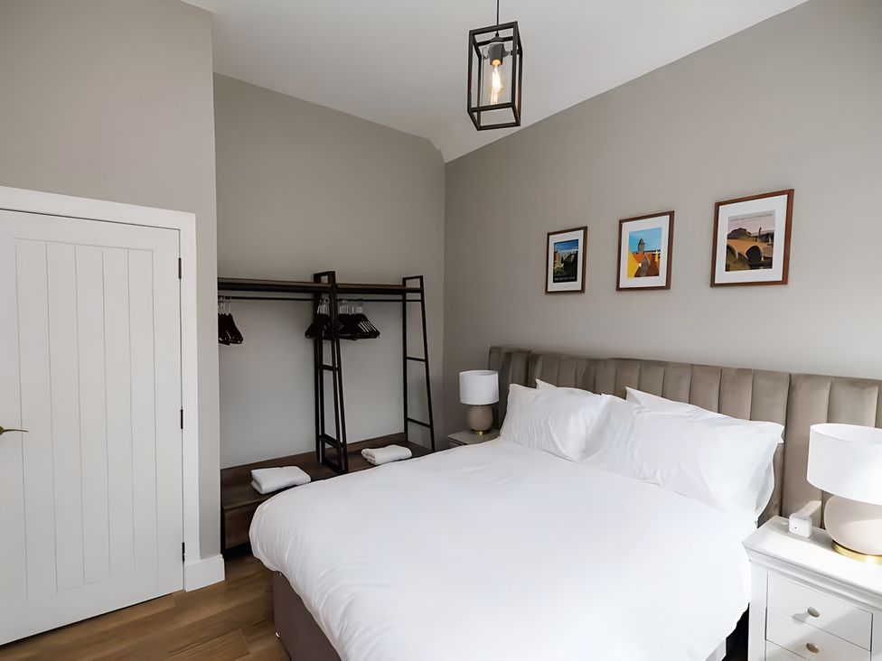 A bedroom with a bed and wardrobe at 15B Kirkgate