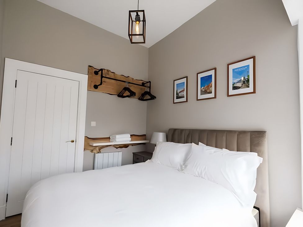 A bedroom with a bed and pictures on the wall at 15B Kirkgate