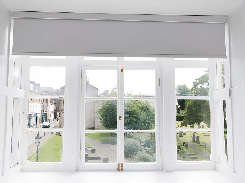 A window view with a street and greenery at 15B Kirkgate