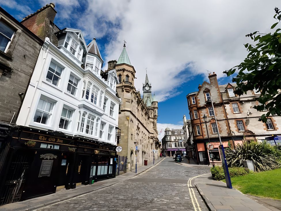 A street scene with buildings and a clock tower at 15B Kirkgate