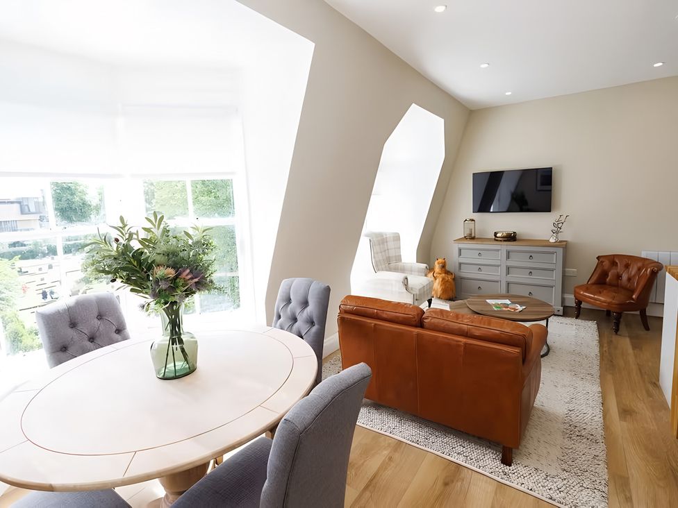 A living room with a dining table and sofa at 15D Kirkgate