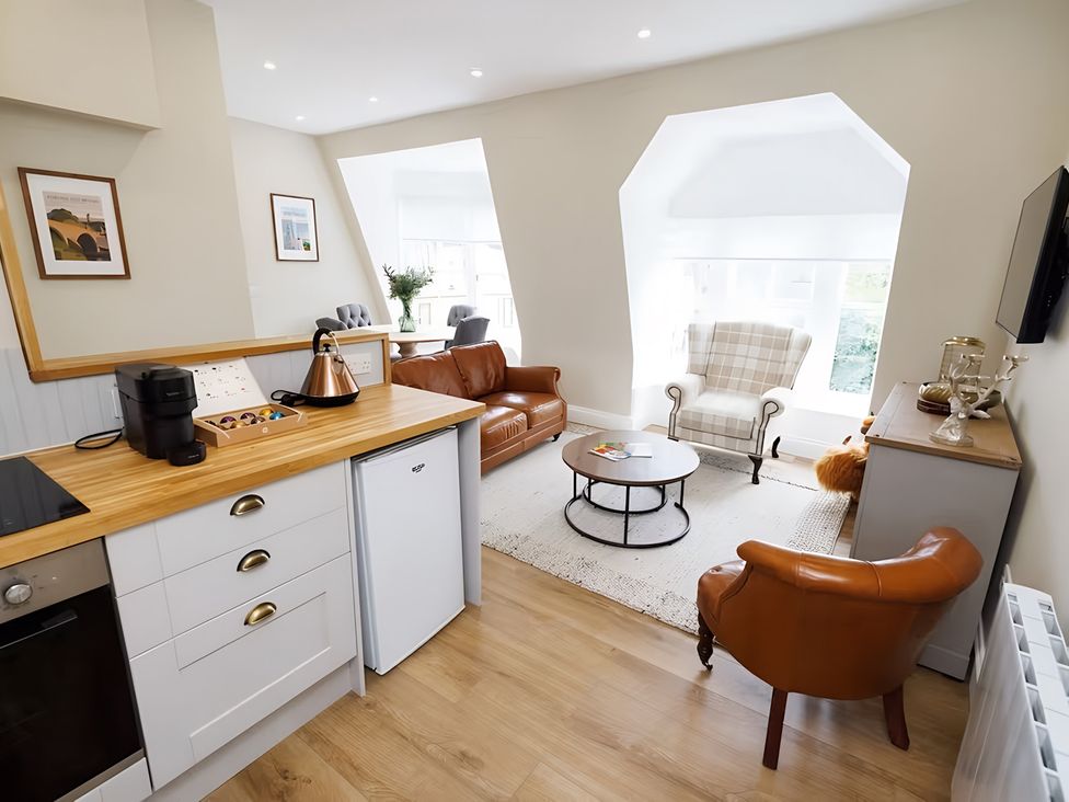 A kitchen and living area with furniture at 15D Kirkgate
