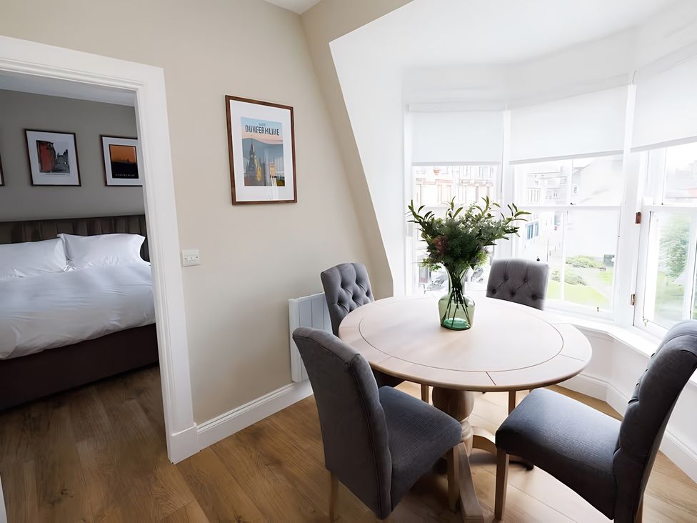 A dining area with a table and chairs at 15D Kirkgate