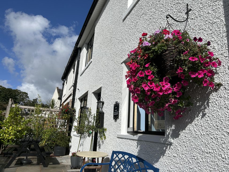 An outdoor area with a flower basket and seating at the property in 