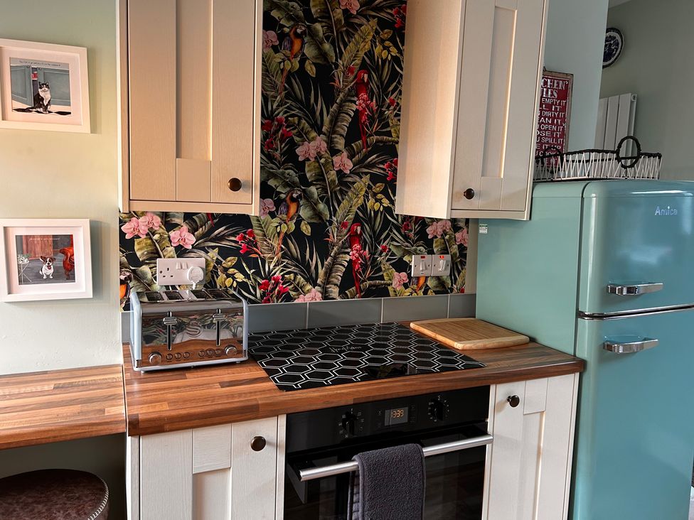 A kitchen with a refrigerator and toaster at The Old Barn in Manchester