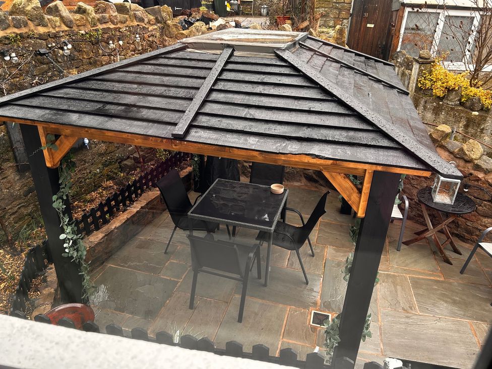 An outdoor seating area with a gazebo and furniture at the property