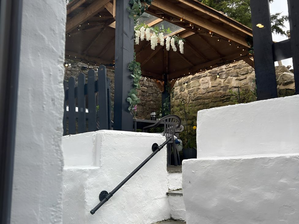 A garden view with a gazebo and stairs at The Old Barn in Manchester