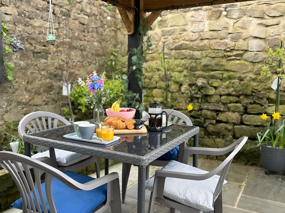 A table with breakfast items in a garden at the property in location