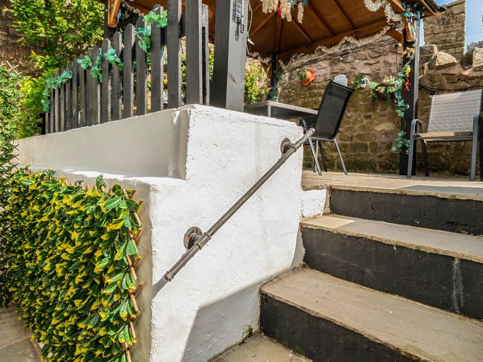 A staircase with a handrail leading to an outdoor area at 20 Main Street Heysham