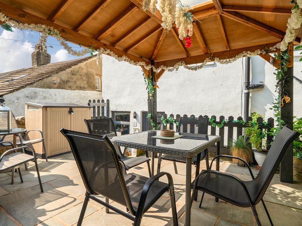An outdoor seating area with a gazebo and table at 20 Main Street in Heysham