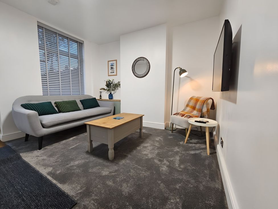 A living room with a sofa and coffee table at 140 Finchley Road