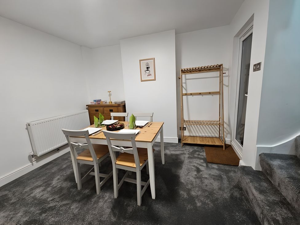 A dining room with a table and chairs at 140 Finchley Road