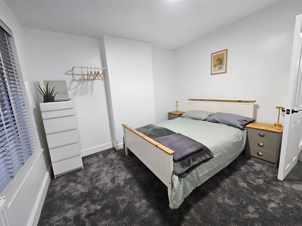 A bedroom with a bed and bedside table at 140 Finchley Road