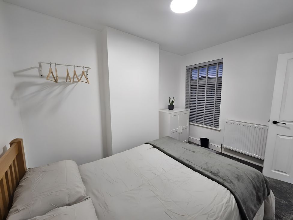 A bedroom with a bed and a cabinet at 140 Finchley Road