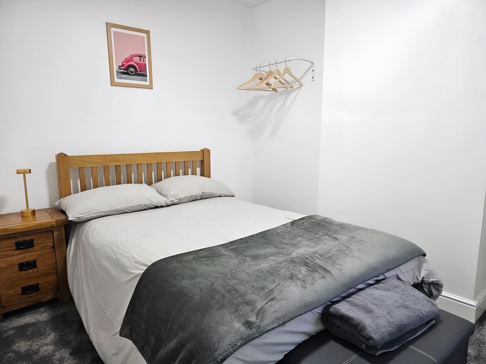 A bedroom with a bed and nightstand at 140 Finchley Road