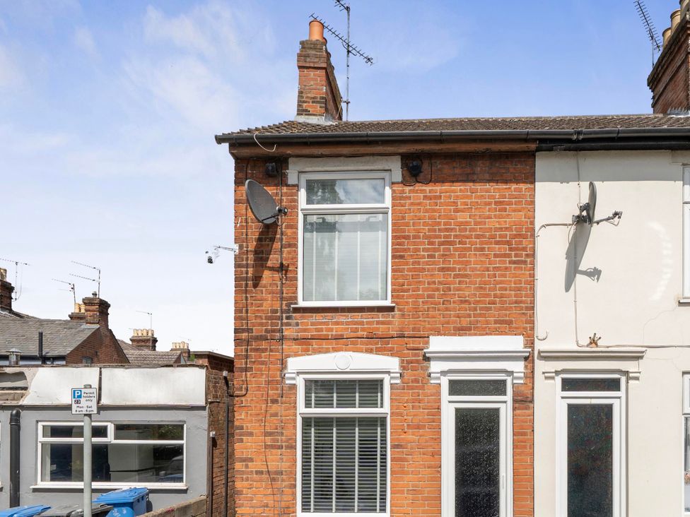 A side view of a house with windows and satellite dish at 140 Finchley Road in Ipswich