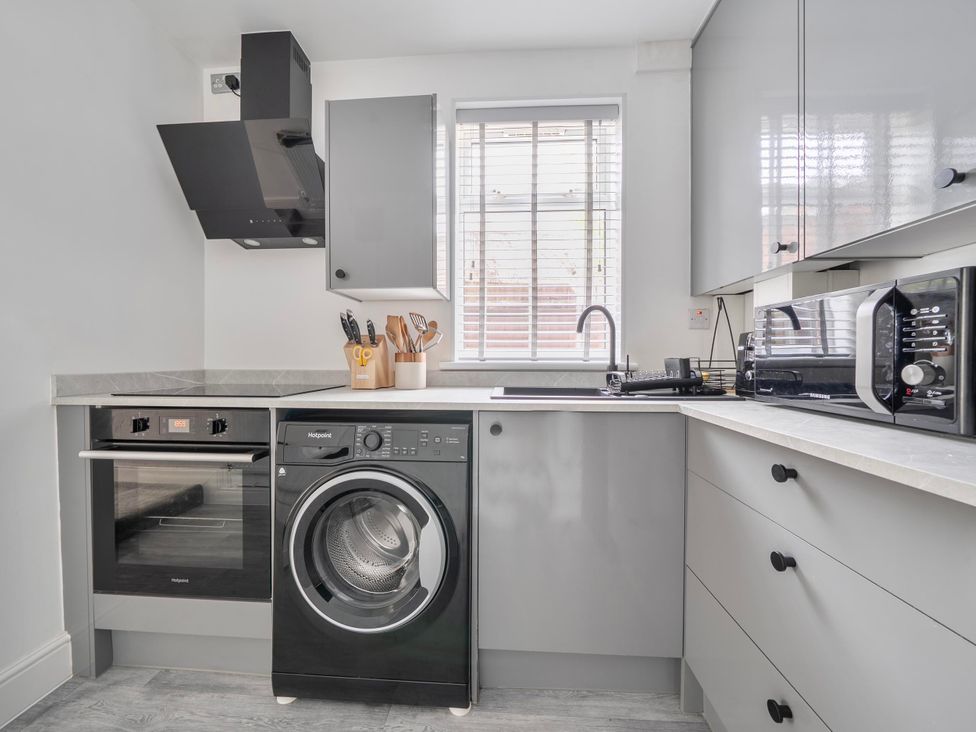 A kitchen with appliances and cabinets at 140 Finchley Road Ipswich
