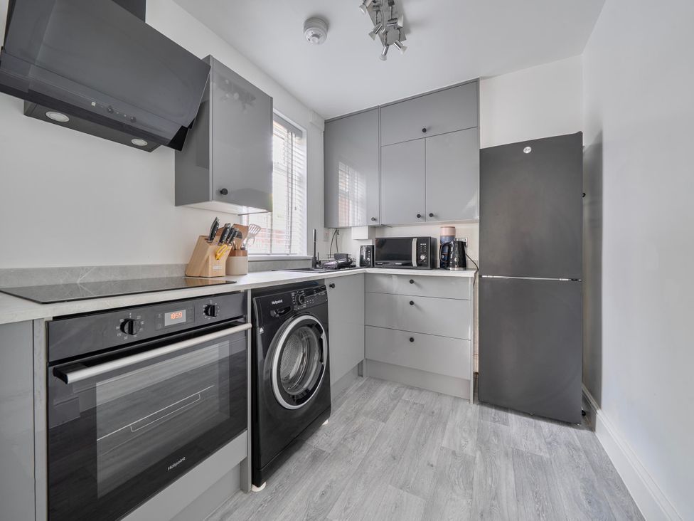 A kitchen with appliances and cabinets at 140 Finchley Road Ipswich