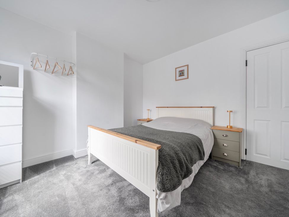 A bedroom with a bed, dresser, and hangers at 140 Finchley Road Ipswich