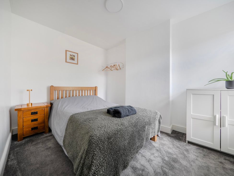 A bedroom with a bed and bedside table at 140 Finchley Road in Ipswich