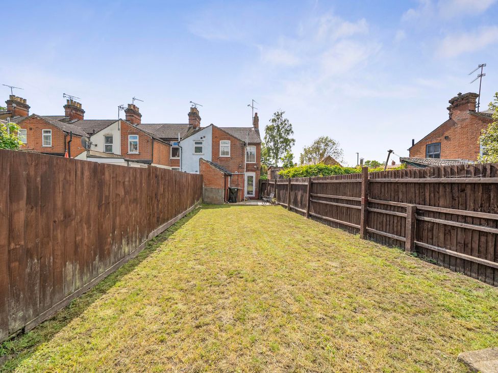 A garden area with grass and wooden fence at 140 Finchley Road, Ipswich