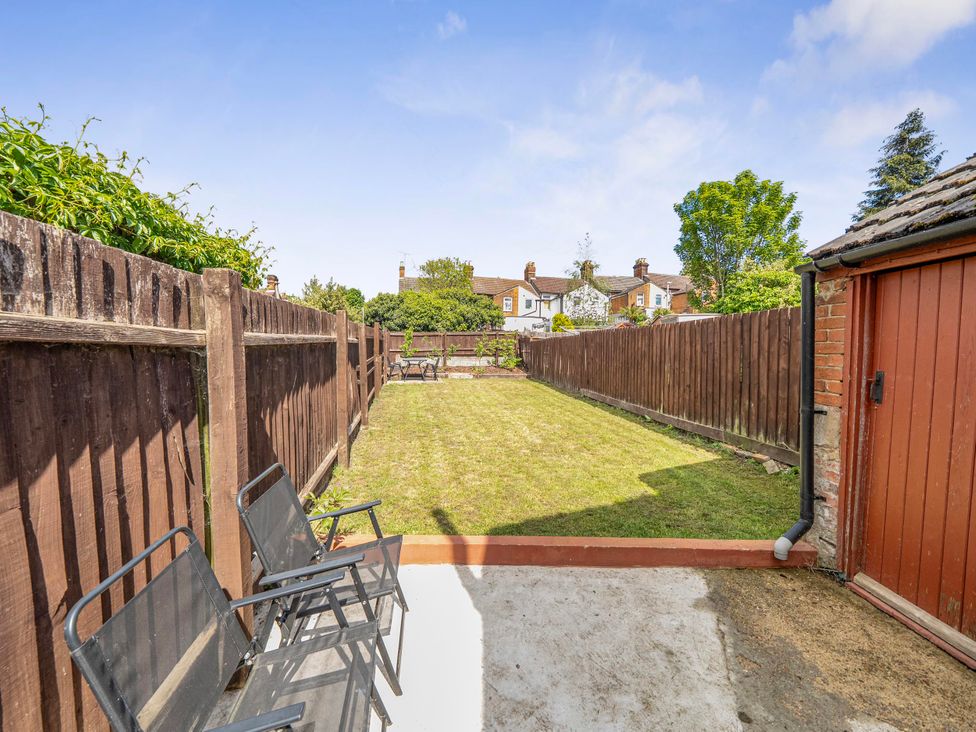A garden with grass and chairs at 140 Finchley Road in Ipswich
