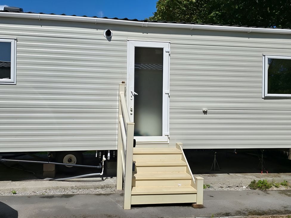 An entrance to a mobile home with steps at Caravan