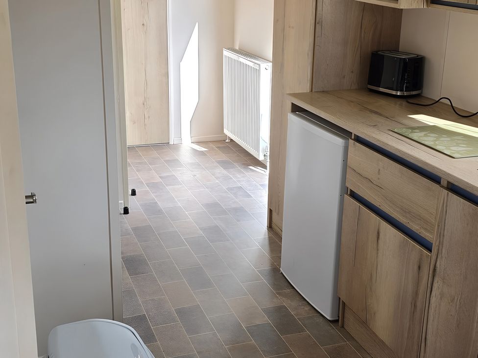 A kitchen with appliances and fixtures at Caravan