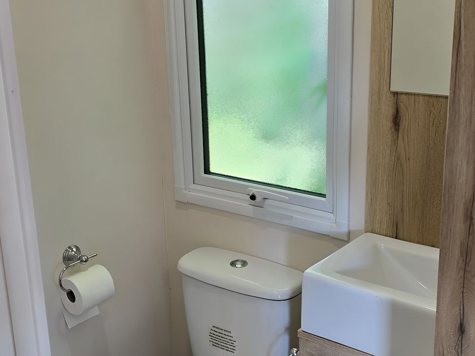 A bathroom with a toilet and sink at Caravan