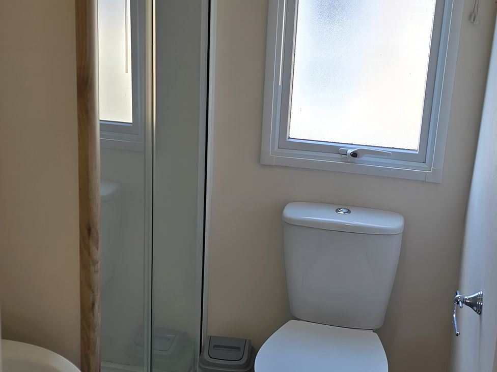 A bathroom with a toilet and shower at Caravan