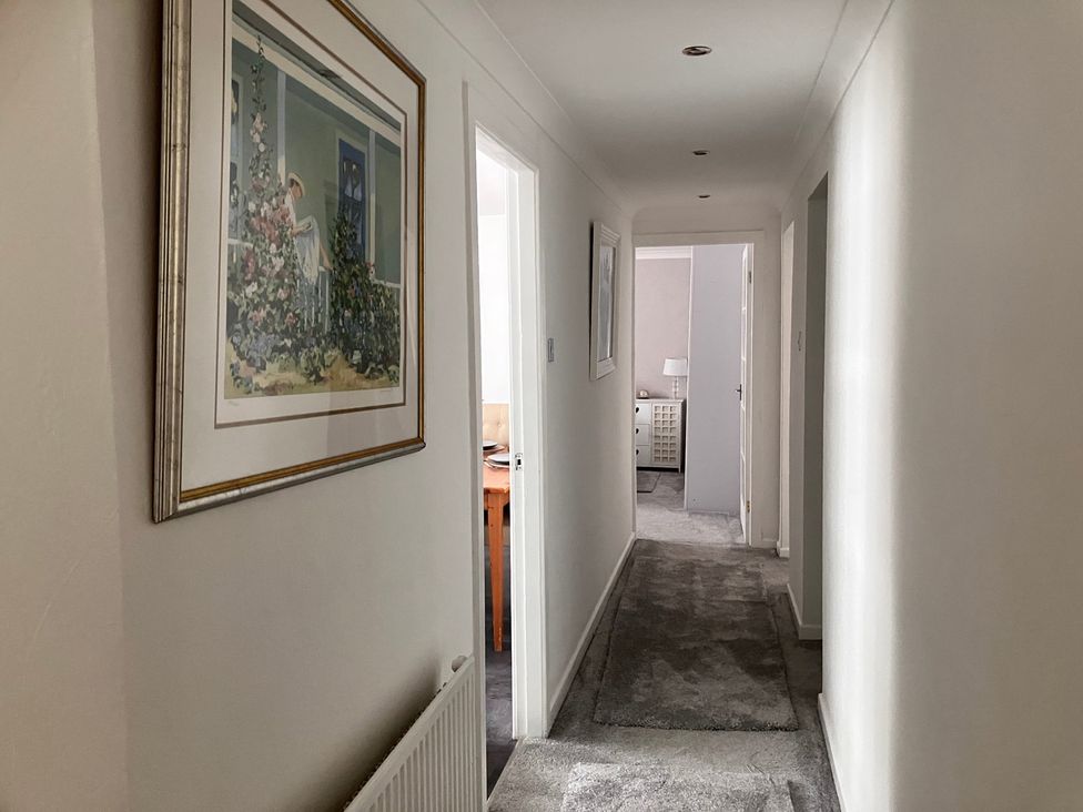 A hallway with a picture on the wall at Flat 2A