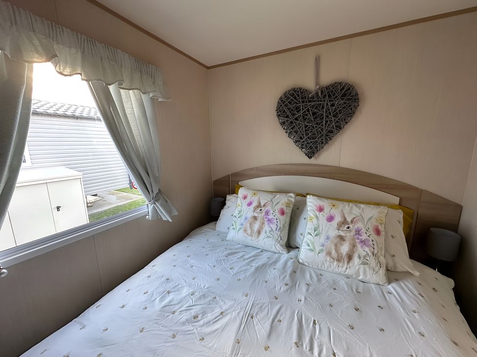 A bedroom with a bed and decorative pillows at the property