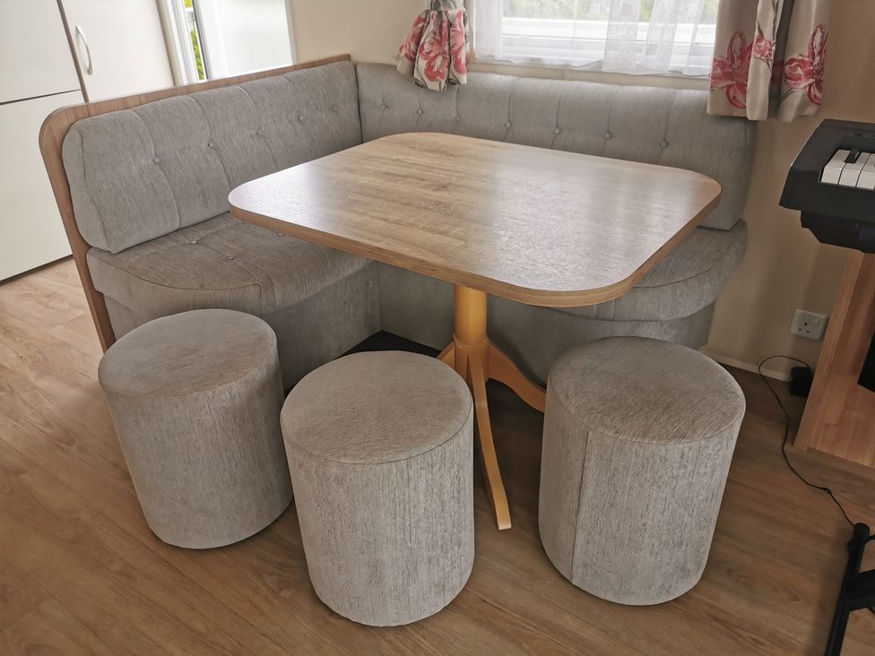A dining area with a table and seating at a property