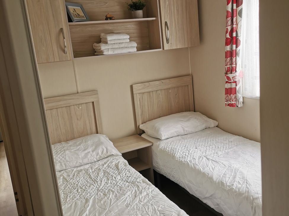 A bedroom with two beds and shelves at the property in the location
