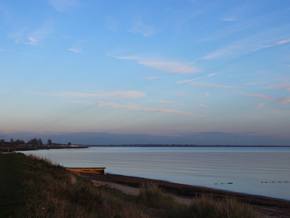 A beach with water and grass at an outdoor location