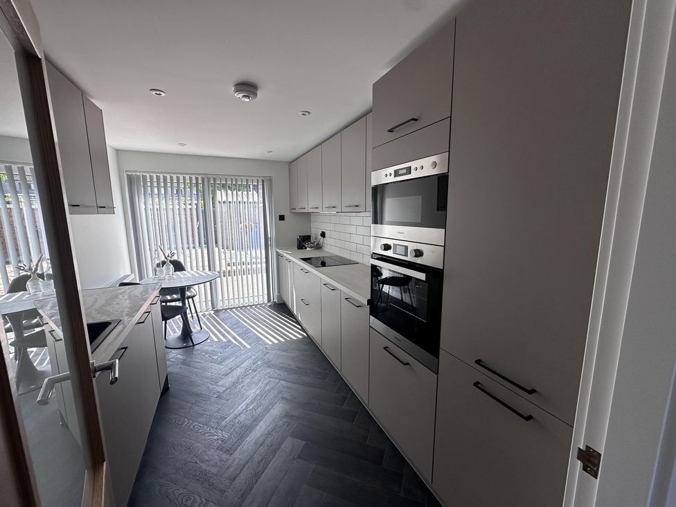 A kitchen with cabinets and appliances at 22 Fraser Avenue