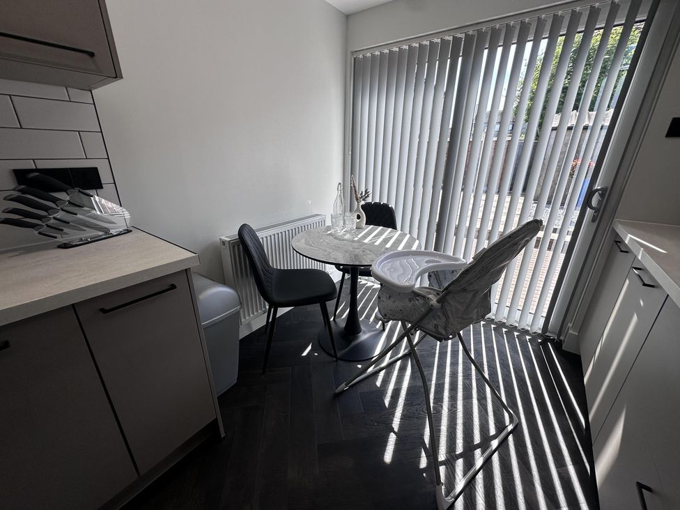 A kitchen with a table and chairs at 22 Fraser Avenue