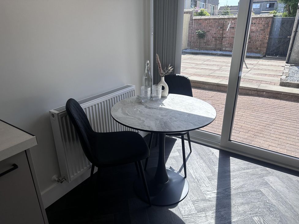 A dining area with a round table and chairs at 22 Fraser Avenue