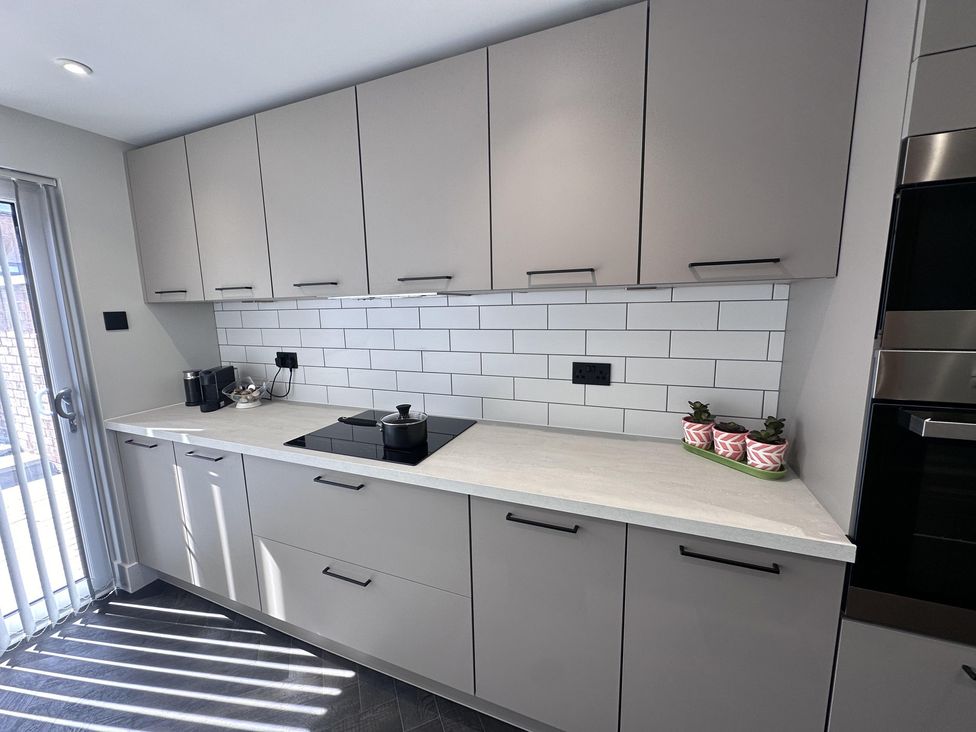 A kitchen with cabinets and a cooktop at 22 Fraser Avenue