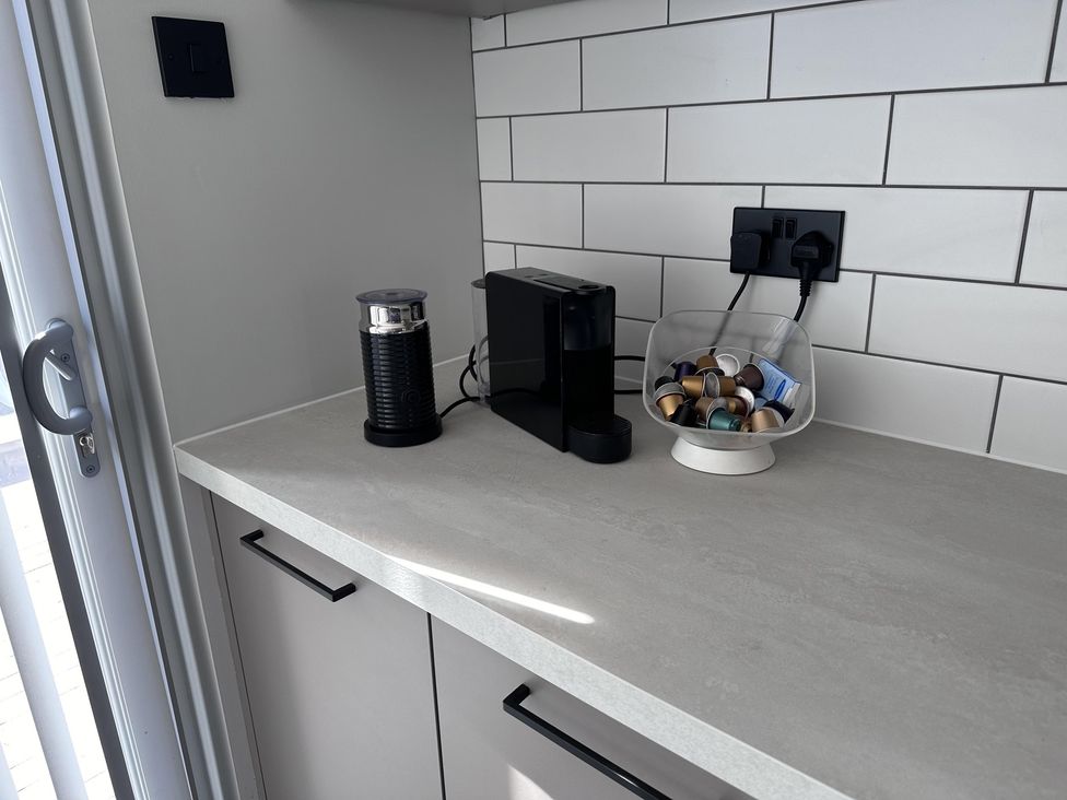 A coffee maker and milk frother on a countertop at 22 Fraser Avenue